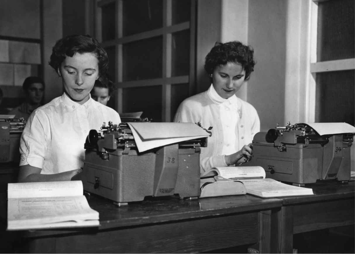 Two students using electric typewriters (1956.)