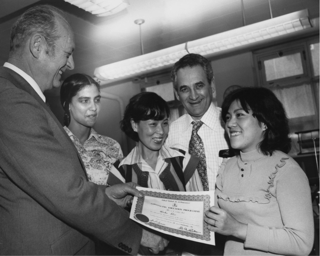 Al Coulson, VSB official, presents a Continuing Education certificate to Helen Oui (1980.)