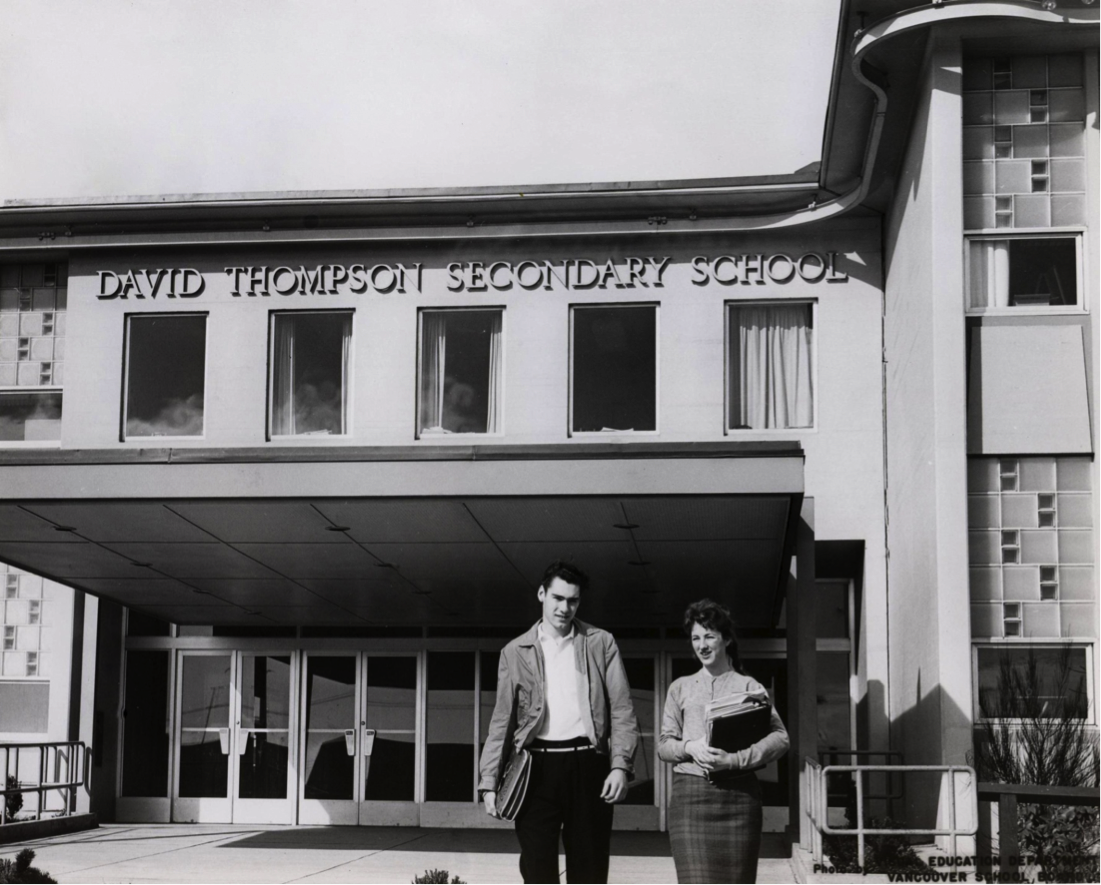 Two students exiting the school at the front entrance (1960.)