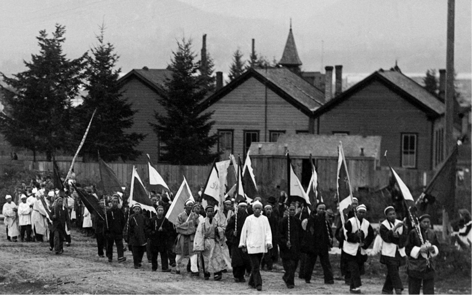 Funeral procession on what is now Kingsway passing in front of three buildings comprising False Creek School (also known as the old Mount Pleasant Building), 1893 (photo courtesy of the Vancouver City Archives.) Click for full-size.